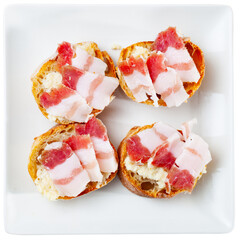 Appetizing sandwiches with salted bacon and horseradish on a plate. Close-up image. Isolated over white background