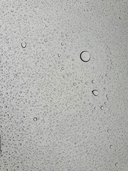 Raindrops on the top window (glass).
Water drops on background.