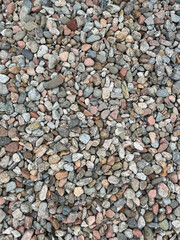 Naklejka premium Small stone texture for background. High quality photo. Rocks on a walk by the water.