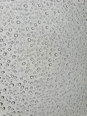 Raindrops on the top window (glass).
Water drops on background.