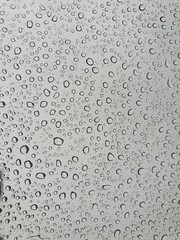 Raindrops on the top window (glass).
Water drops on background.