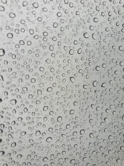 Raindrops on the top window (glass).
Water drops on background.