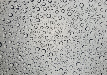 Raindrops on the top window (glass).
Water drops on background.