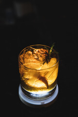 bartender preparing Manhattan drink with cherry and ice

