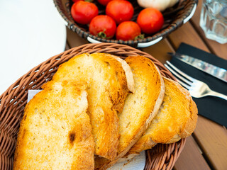 Ingredients for traditional Spanish snack Pa amb tomaquet served on table. Crispy toasted bread,...