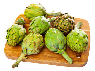 Obraz premium Pile of fresh organic green artichokes, ingredients for cooking at home. Isolated on white background