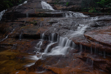 Fototapeta premium Water flowing through a rocky cascade.