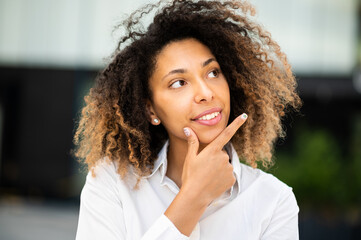 Confident young afro american female manager outdoor in a pensive expression