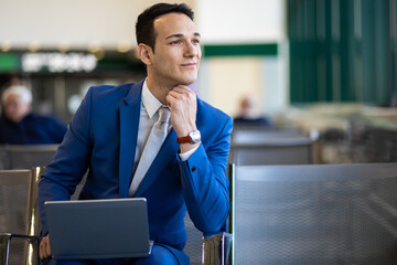 Young businessman working with his laptop in an airport