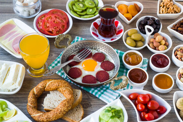 Traditional Turkish Village Breakfast on the wooden table with  copper egg pan and bagel