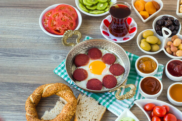 Traditional Turkish Village Breakfast on the wooden table with  copper egg pan and bagel
