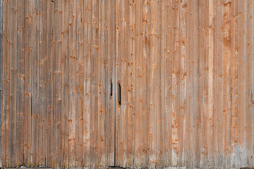 Background of a large wooden barn door which is closed