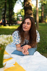 girl in a blue dress in the park at a picnic on vacation