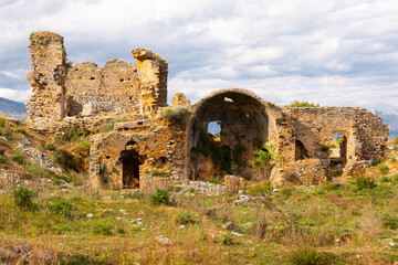 Remains of Anemurium basilica with view of semicircular apse. Close to modern Turkish city of Anamur. - obrazy, fototapety, plakaty