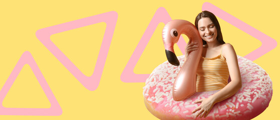 Young woman with big sweet donut on color background