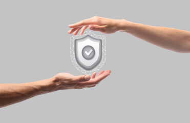 Hands and icon of antivirus on grey background