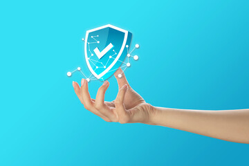 Female hand and icon of antivirus on light blue background
