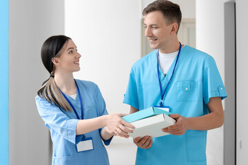 Medical assistants with folders in clinic