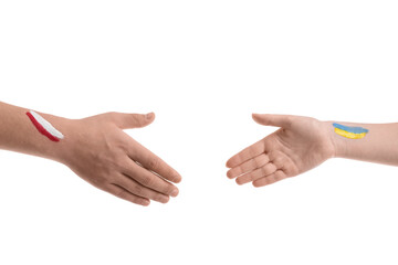 Volunteers with drawn flags of Ukraine and Poland reaching out for handshake on white background