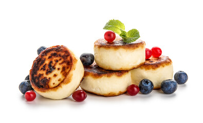 Delicious cottage cheese pancakes with berries and mint leaves on white background