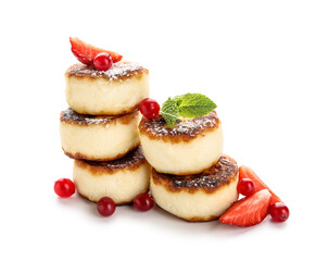 Stack of delicious cottage cheese pancakes with berries and mint leaves on white background