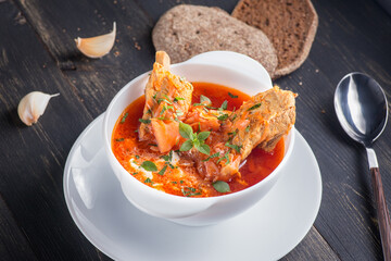 Traditional Ukrainian Russian borscht on the table. Borscht with meat and sour cream. Beetroot borscht with parsley. High-quality photography