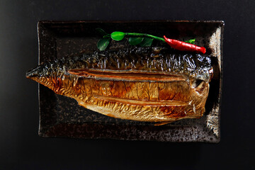 Grilled fish dish mackerel on the table - obrazy, fototapety, plakaty