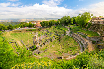 The ancient ruins of the Roman Theatre or  Teatro Romano outside the city walls of the Tuscan hilltop medieval town of Volterra, Italy.