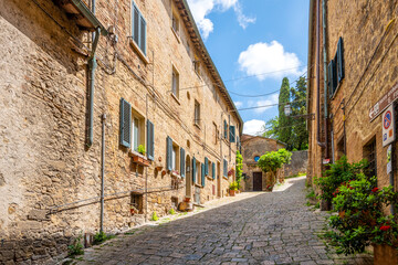 A narrow stone alley in the hill town of Volterra, Italy.