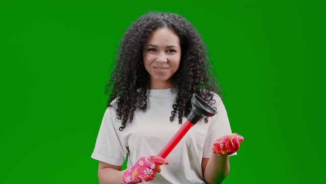plumber looking to the camera smiling holding plunger Isolated on Green Screen