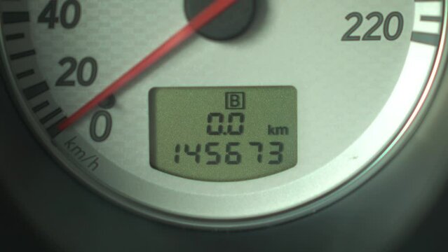 Resetting the mileage indicator board on the panel in the car. Automotive panel close-up.