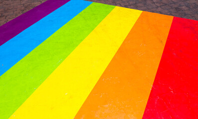 Colorful Rainbow flag on floor.