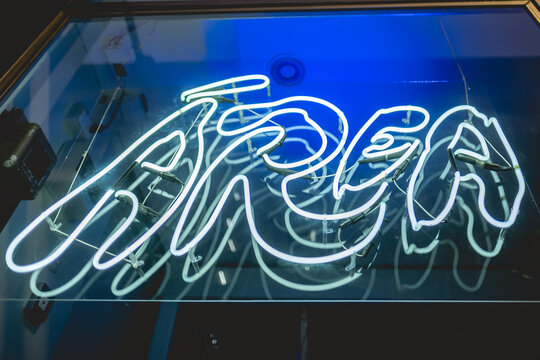 'Área' coffee shop with white neon sign in the night with dark blue lights, Santiago, Chile