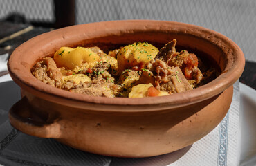 Traditional South American carbonada criolla (beef stew) in a rustic clay pot. Salta, Argentina.