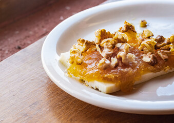 Handmade fibrous cayote or alcayota (Cucurbita ficifolia) jam with quesillo (homemade cheese) and nuts as a topping. Typical dessert from the Northwest Region of Argentina. 