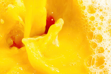 Obraz na płótnie Canvas Closeup of splashing orange juice, top view. Splash of fresh sweet orange, mango, fruit juice. Freeze motion of pouring orange juice .