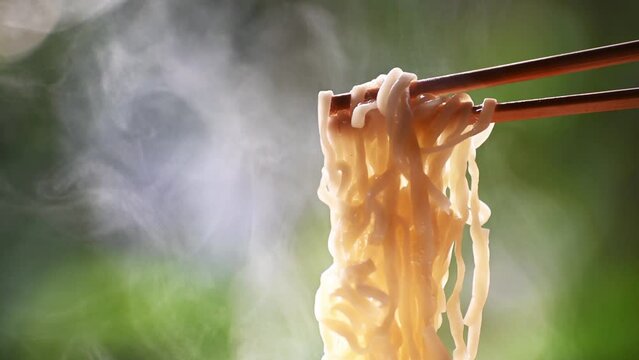 closeup footage of chopsticks nipping chinese noodle
