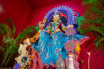 Idol of Goddess Saraswati with veena, a musical instrument and white swan, a sacred bird, at Kolkata, West Bengal, India. Saraswati is Hindu goddess of knowledge, music, art, wisdom, and learning.