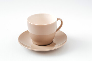Empty beige coffee ceramic cup and saucer on isolated white background, cut out