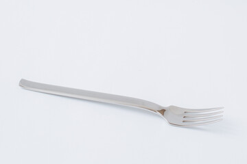 Empty steel fork on white background, copy space