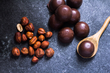Chocolate truffle with walnuts and wooden spoon