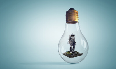 Spaceman inside light bulb . Mixed media