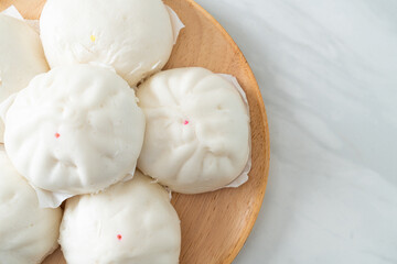 stuffed steamed bun on wood plate