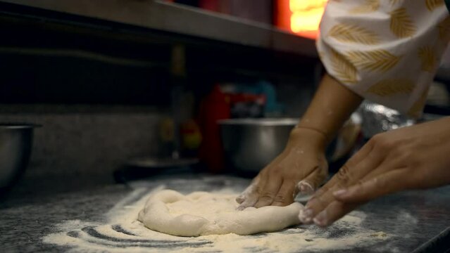 girl prepares pizza in the kitchen at the restaurant. big frame