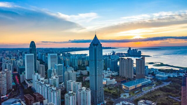 Aerial Hyperlapse of Urban Landscape in the Coastal Central Business District during Sunset, Haikou City , Hainan Province, China, Asia.