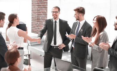 handshake of a young employee with the project Manager