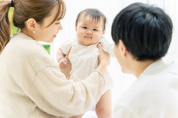 赤ちゃんと遊ぶ両親　家族イメージ