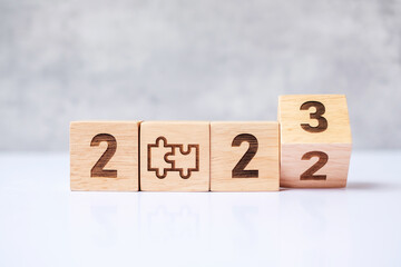 flip 2022 to 2023 block with jigsaw puzzle icon. Business Process, Team, teamwork, Goal, mission,...