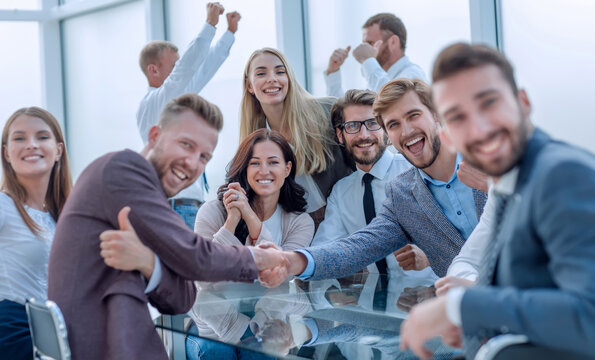 Happy Business People Shaking Hands In The Conference Room