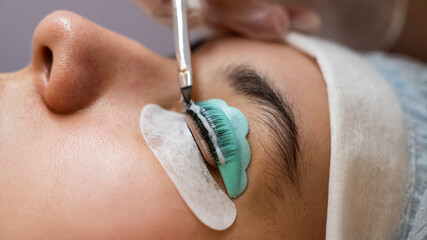 Close-up portrait of a woman on eyelash lamination procedure. 